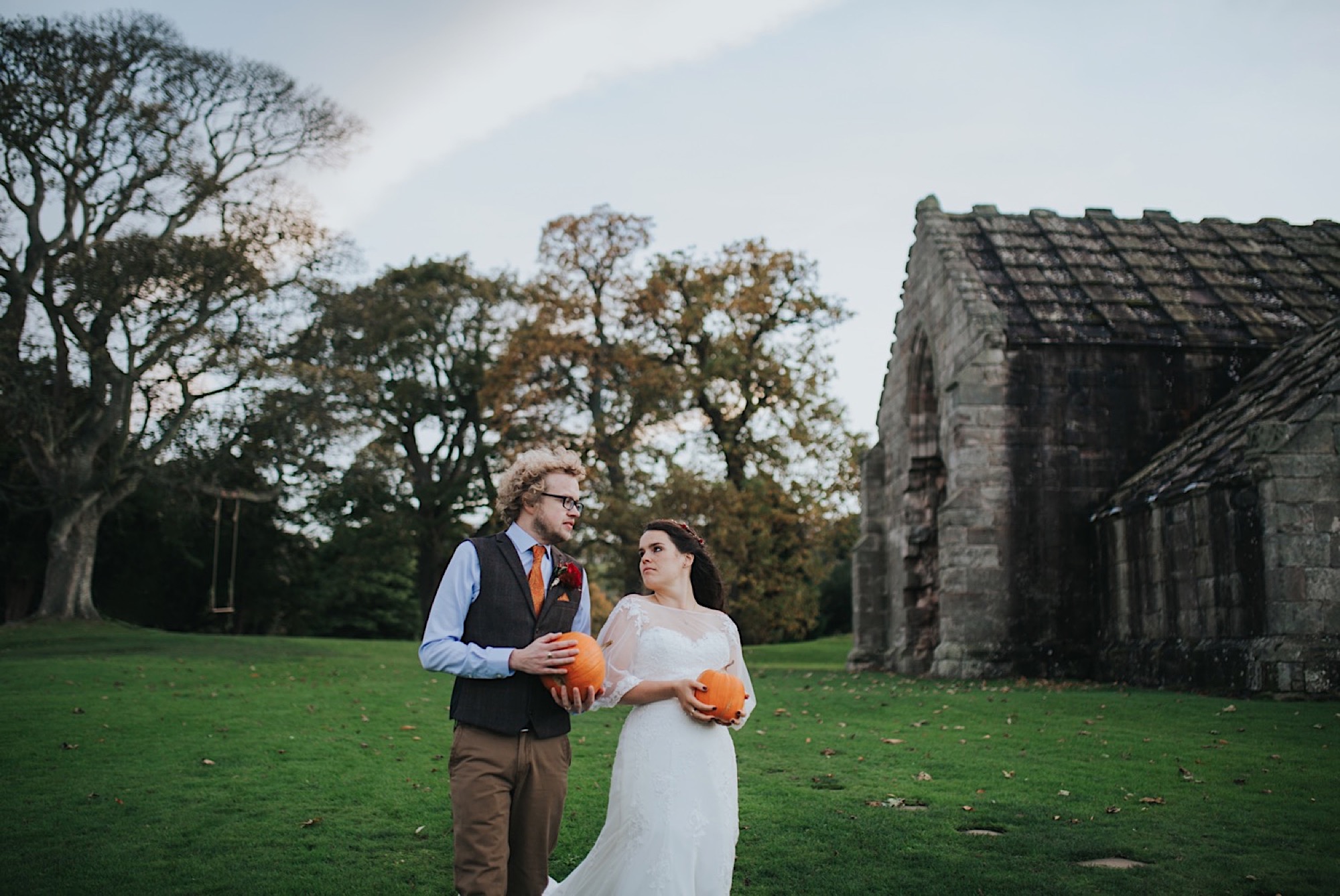 bride and groom portraits with pumpkin