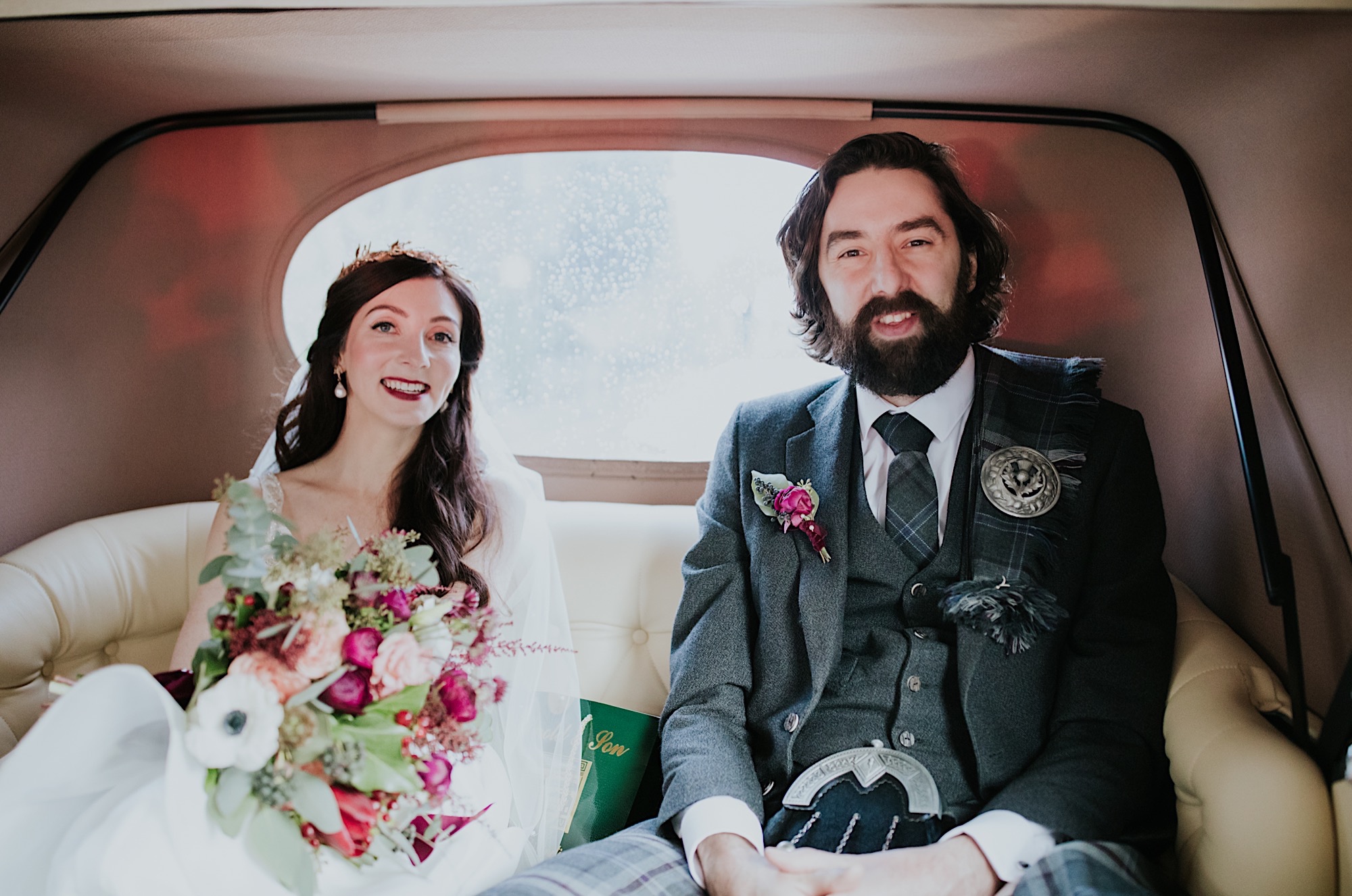 bride and groom in their wedding car